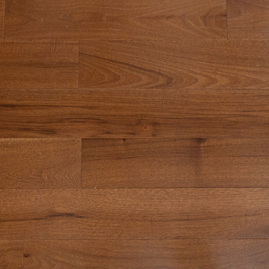 Reddish-brown hardwood floorboards with varied grain and visible plank seams