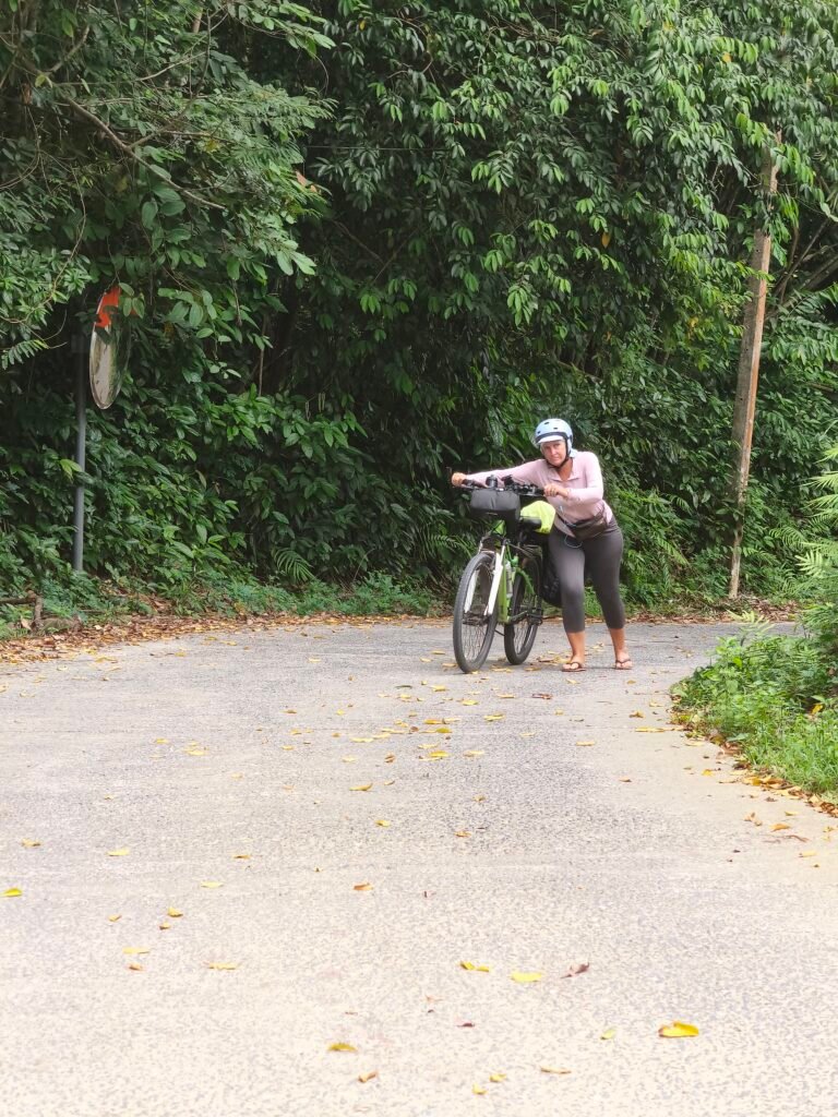 Joanna full force pushing the hill bikepacking Thailand