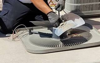 HVAC technician servicing a fan system