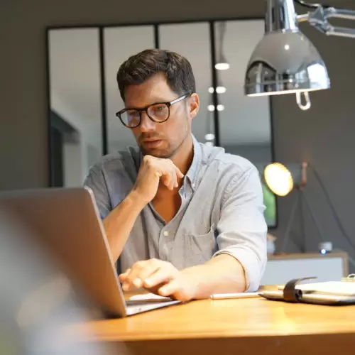 Middle-aged man working on laptop in office
