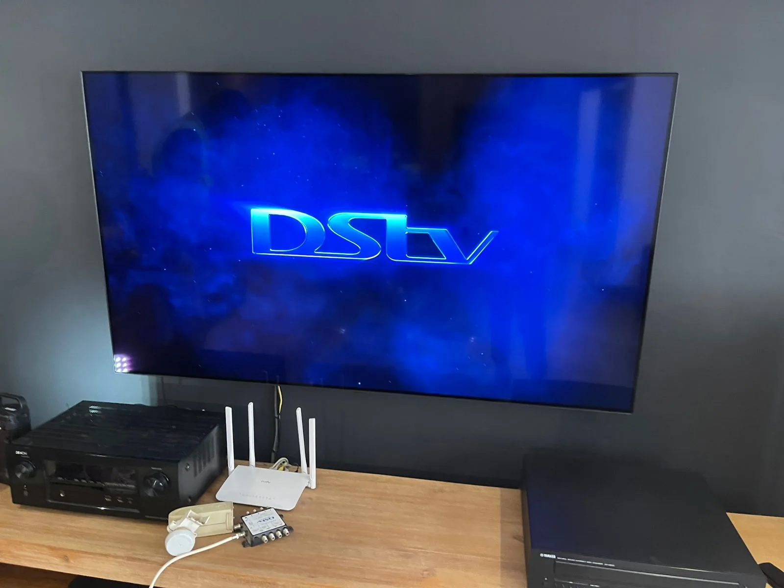 DStv home theatre setup with large TV and decoder configuration