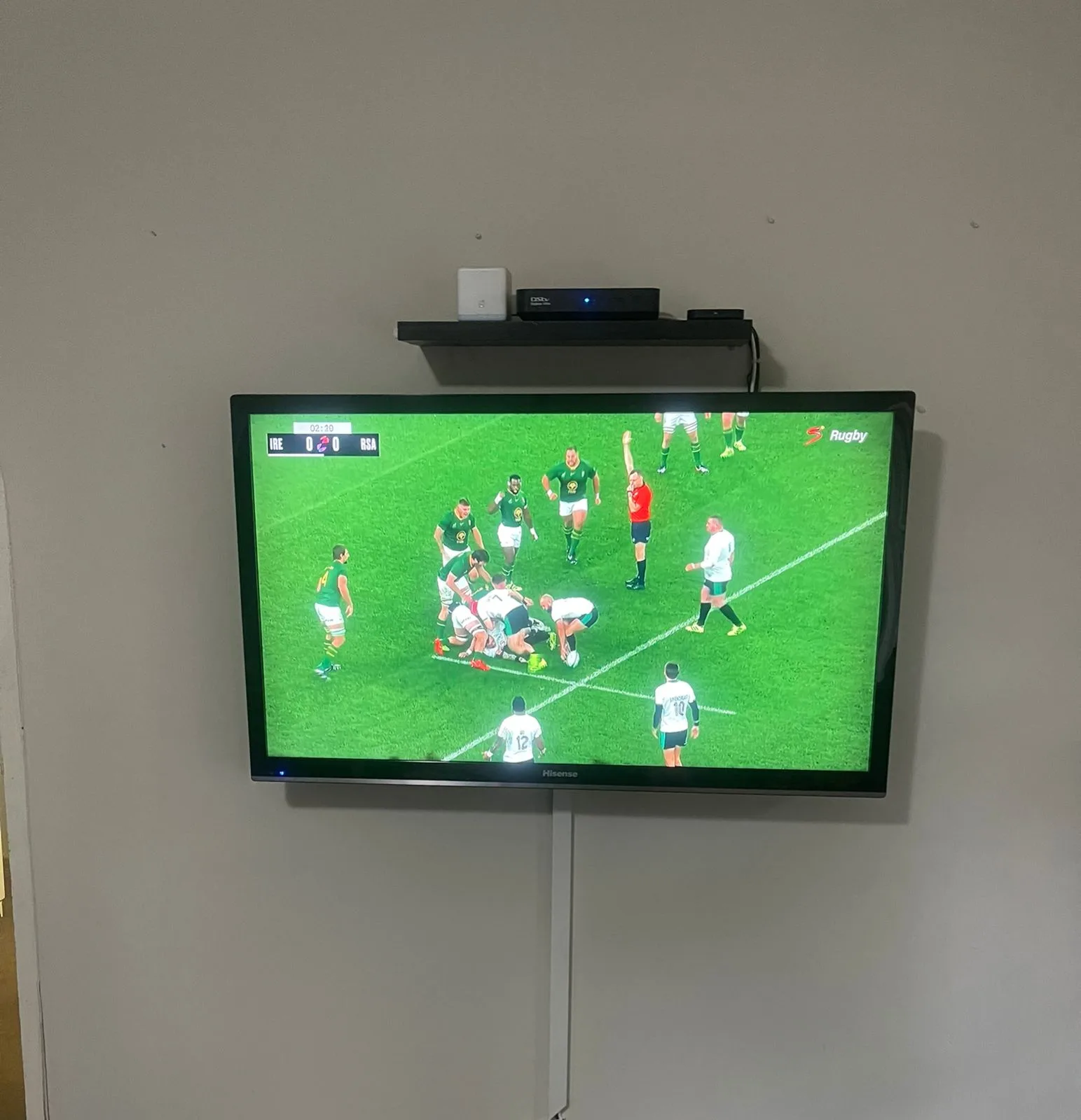 DStv Explora decoder installed in a wall-mounted TV lounge setup