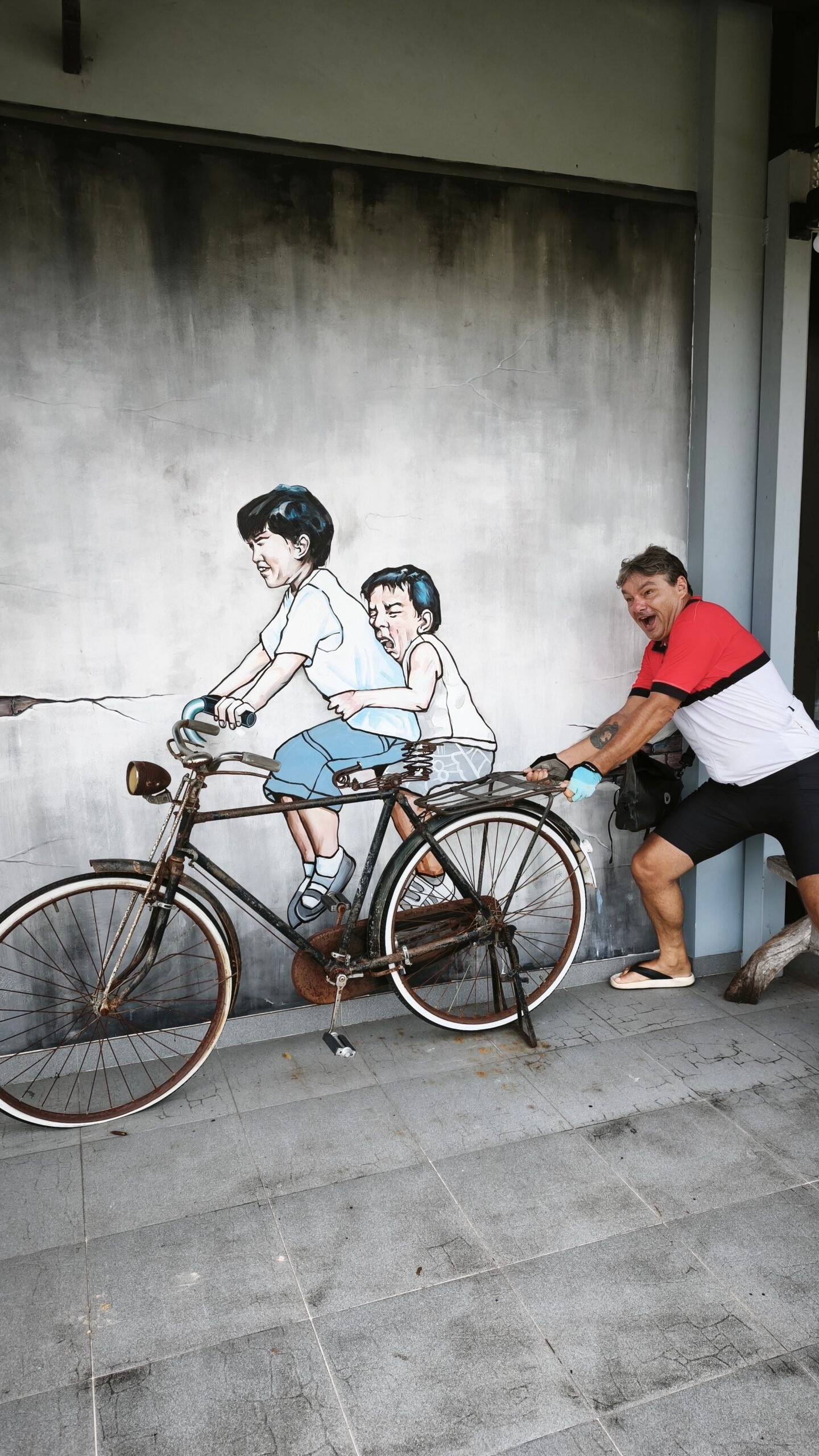 Maurice pushing a bicycle in Thailand