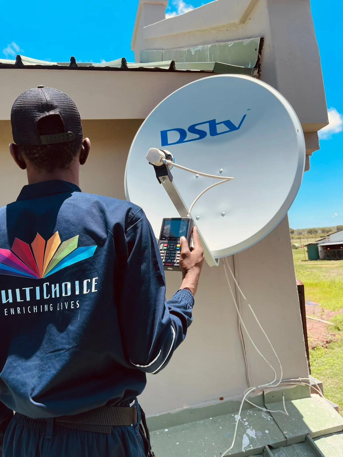 Accredited DStv technician performing satellite dish alignment