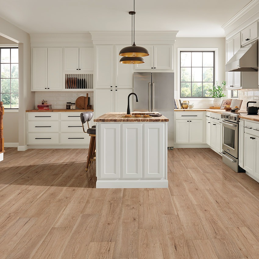 light brown laminate flooring installed on display in a modern white and natural wood decor kitchen