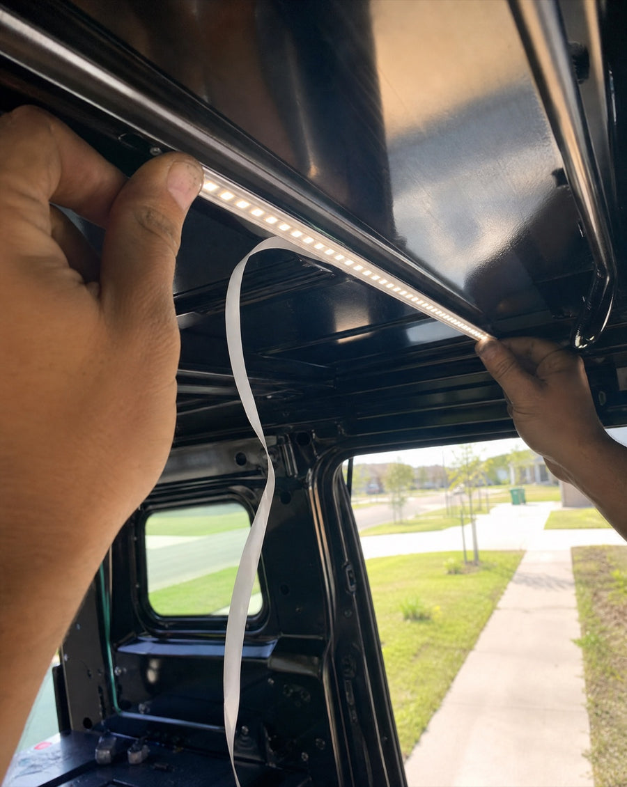 Pressing the LED bar into the truck cap ceiling channel for a clean install