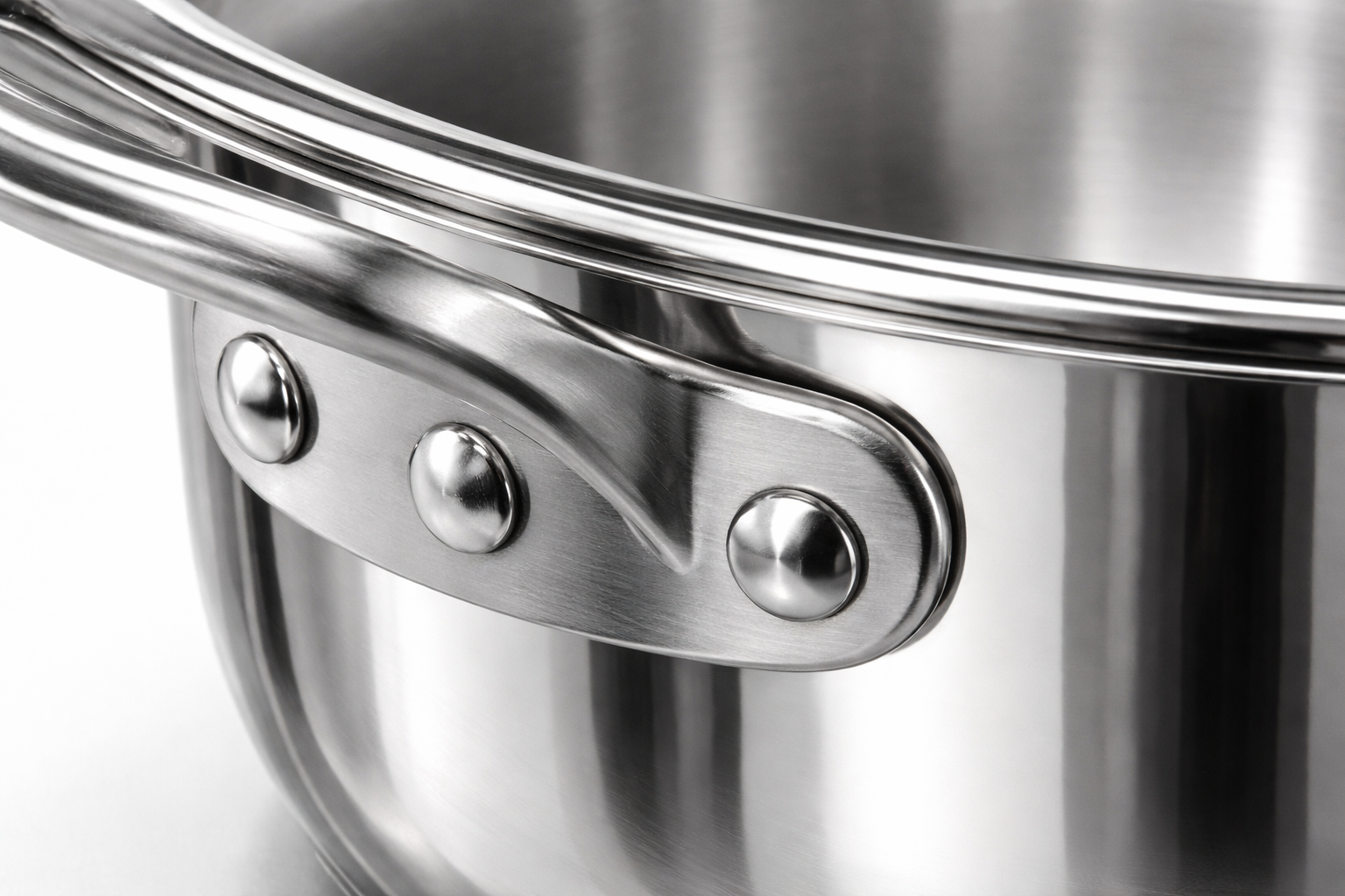 Detailed view of stainless steel riveted handle and polished surface finish