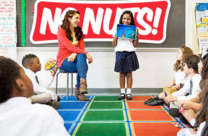 Elementary classroom with children and teacher, No Nuts! allergy-friendly sign on chalkboard