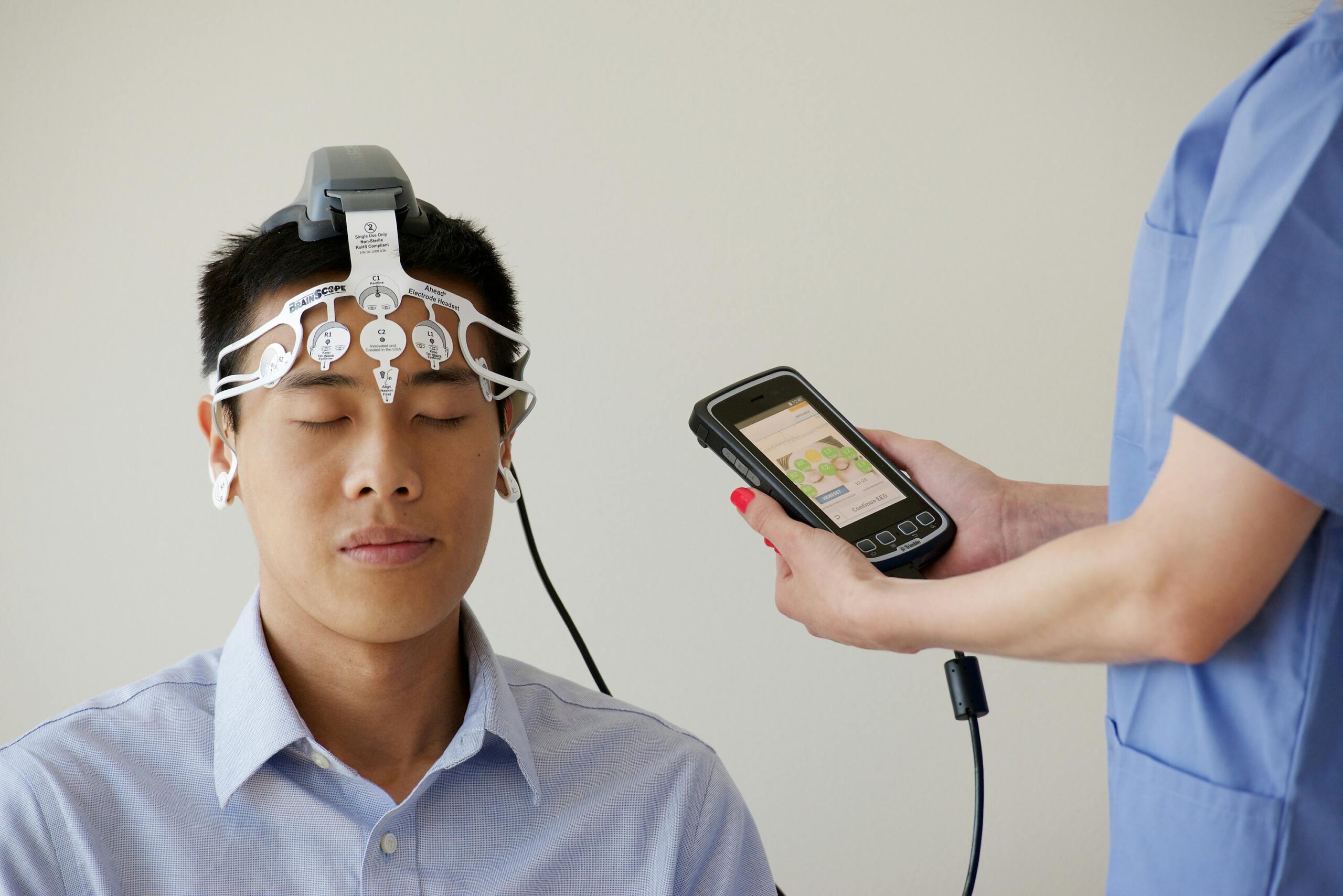 Healthcare professional conducting EEG examination on patient