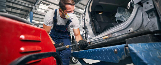 Technician using PDR tool on vehicle