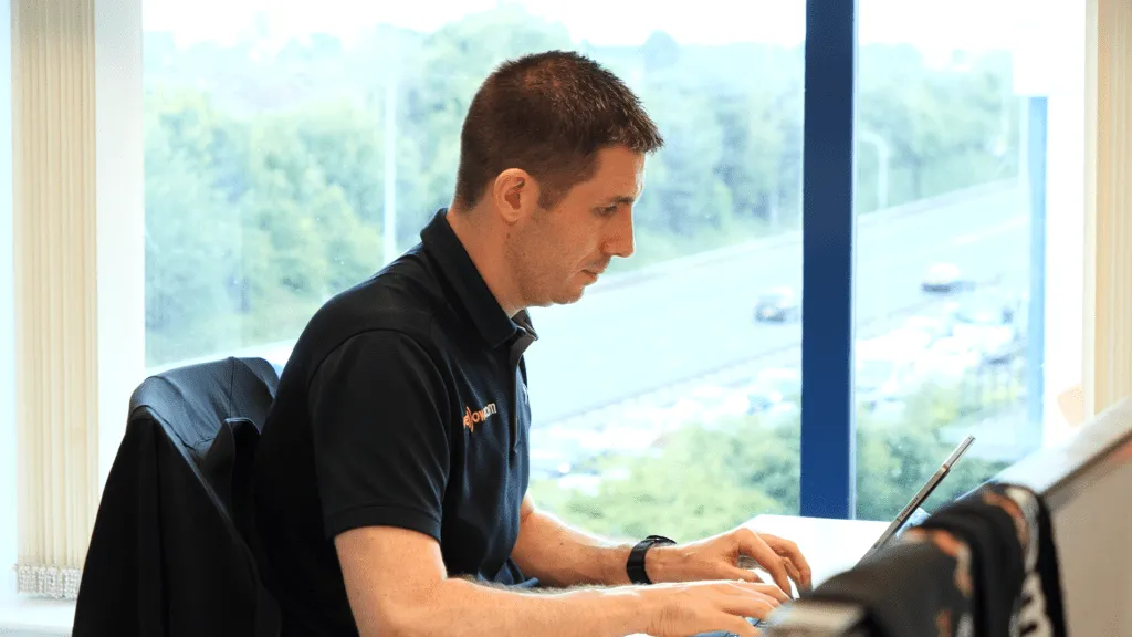 man at desk working Business Phone Systems & Cloud Communications