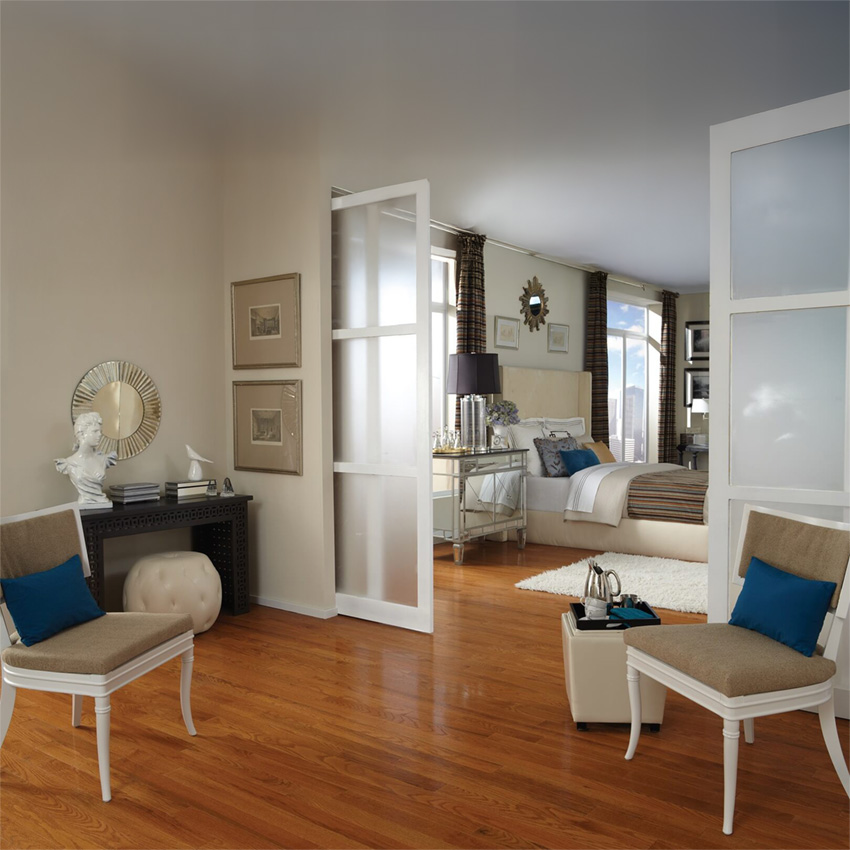 Living room with warm brown hardwood flooring and white furniture