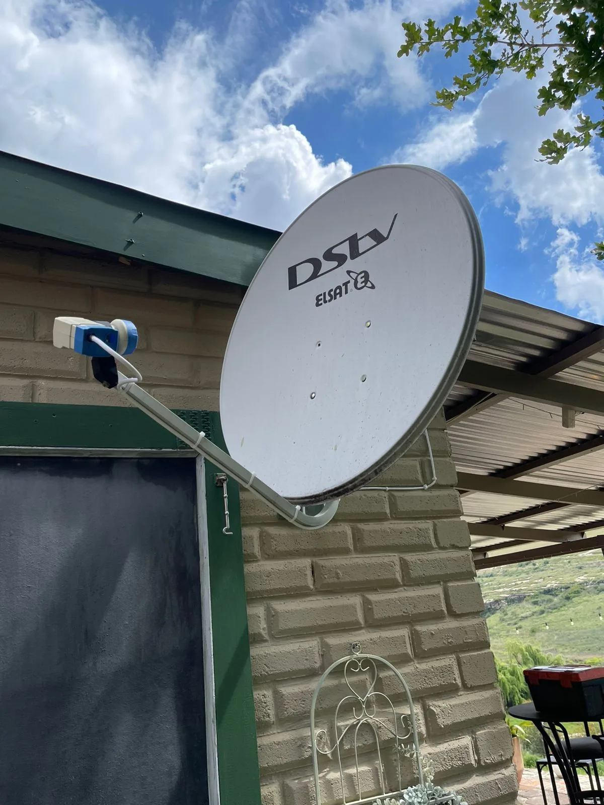 DStv ELSAT dish installed on a face brick wall