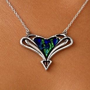 Archibald Knox style pewter pendant with openwork wings and heart-shaped enamel inlay