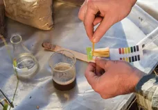 Technician performing a soil test before planting grass seed