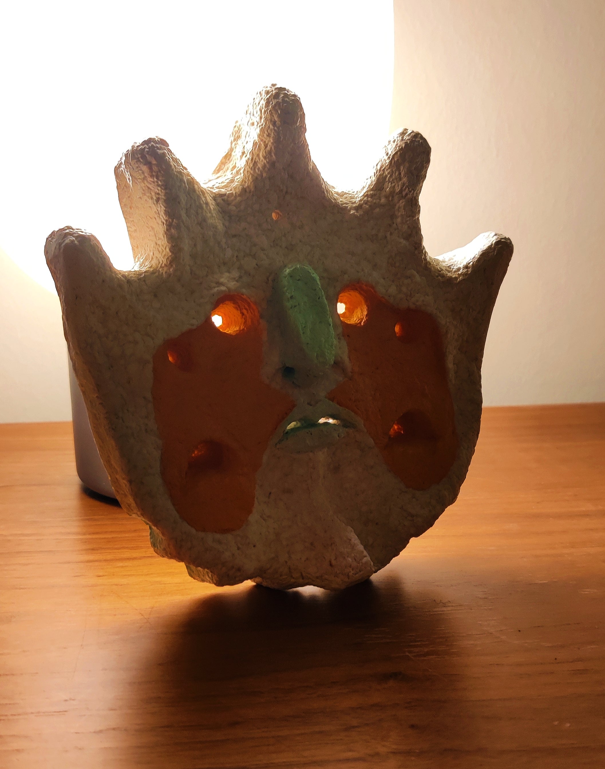 The Sun King paper pulp wall art with backlight showing the eyes