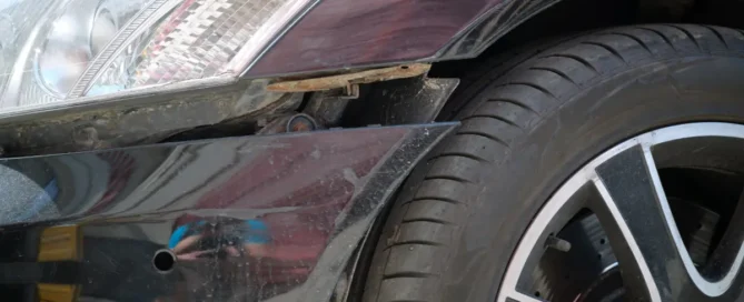 Dented car fender damage needing collision repair